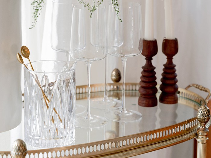Entertainment cart with crystal wine glasses and gold spoons